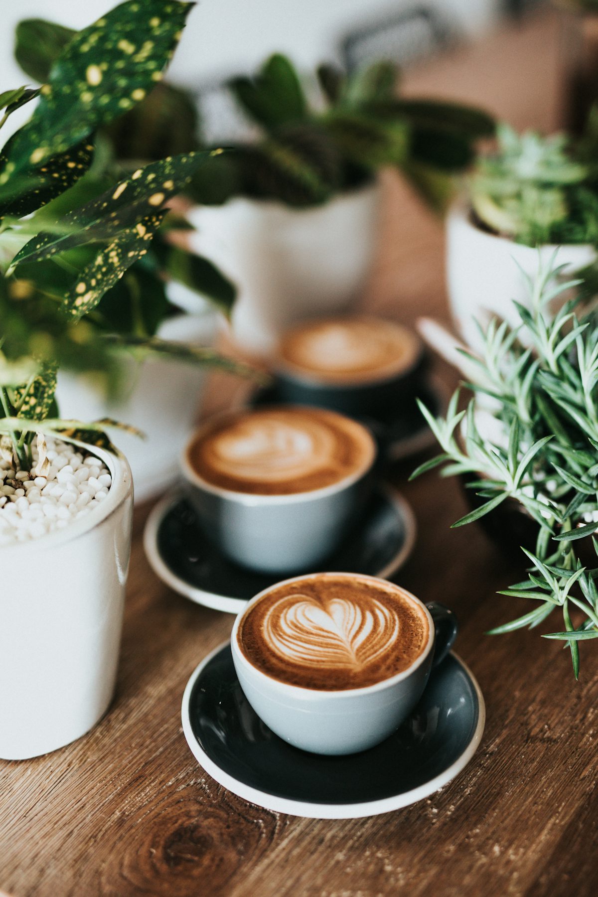 Latte art in a ceramic cup on a clean marble surface, soft natural light