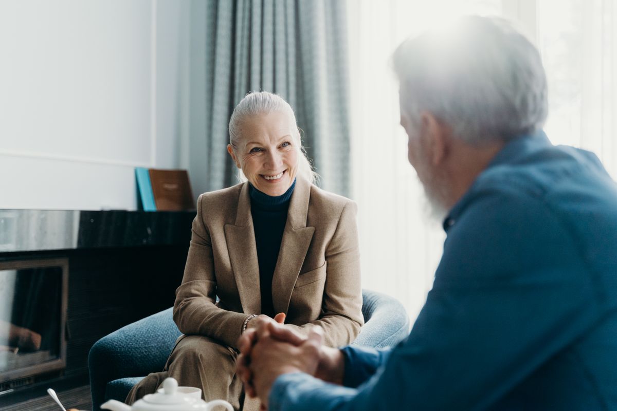 Senior couple having a cheerful conversation at home